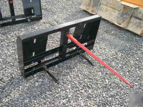Round bale forks for skid loader